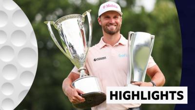 Wyndham Clark smiling and holding two trophies