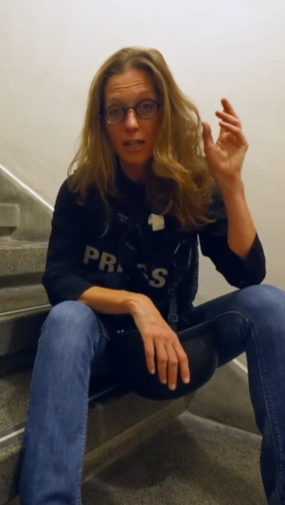 Lucy Williamson sat in stairwell