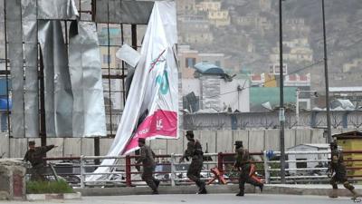 Afghan security personnel arrive at the scene after the blast