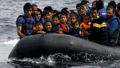 Afghan migrants arrive on the Greek island of Lesbos in an overcrowded dinghy