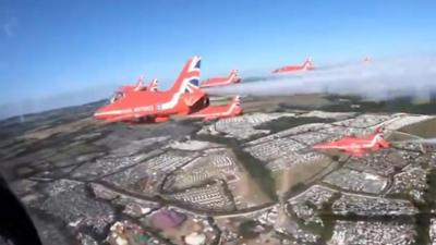 Red Arrows fly over Glastonbury site