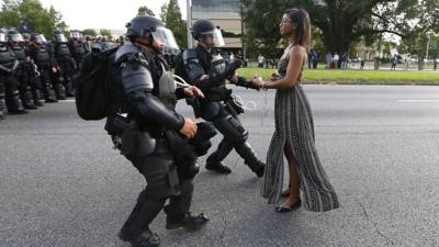 protester confronts police officers