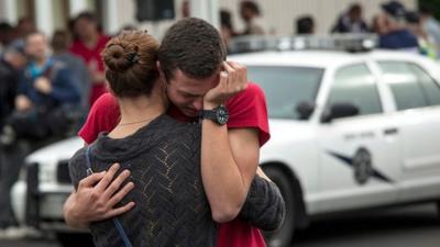 Student embraces a family member