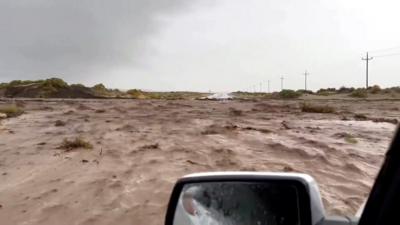 Car stranded in rising floodwaters