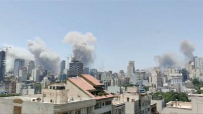Smoke rising over a city skyline