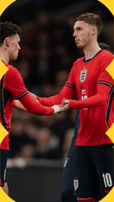 Phil Foden and Cole Palmer shake hands wearing England kit 