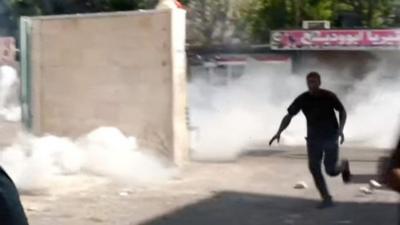 Man running from tear gas