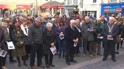 People in Caernarfon observing the Aberfan minute's silence