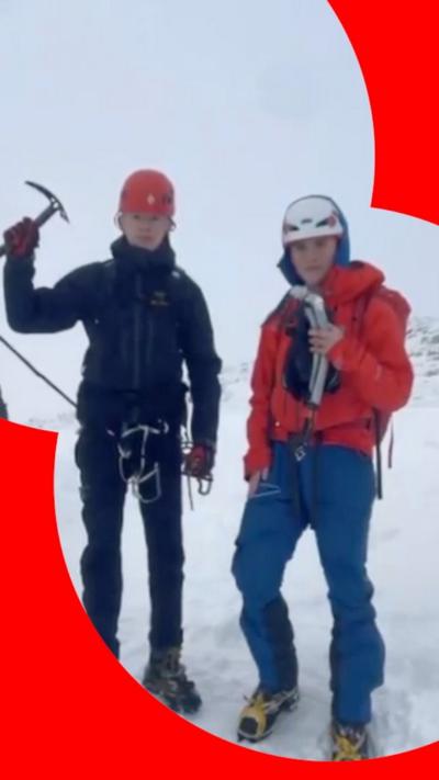 teenage boys on snowy mountain in mountain climbing gear