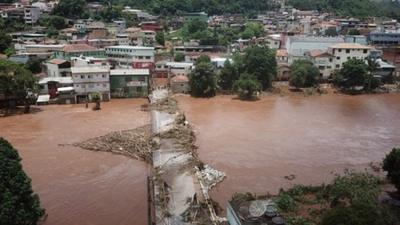 Swollen river and damaged bridge