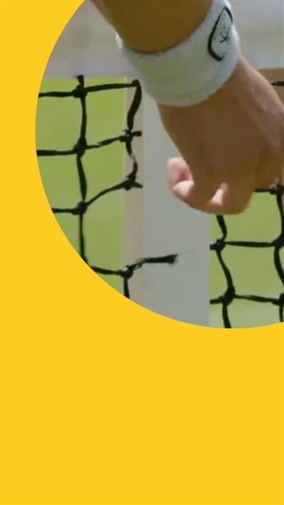 Hand wearing a sweat band pointing to a hole in tennis net