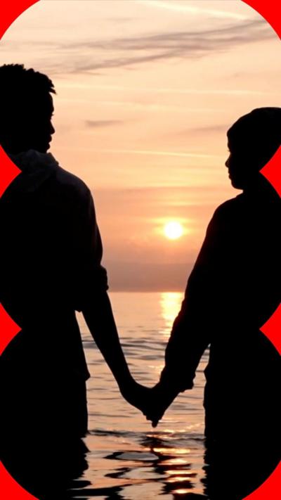 Couple by the sun in the sea