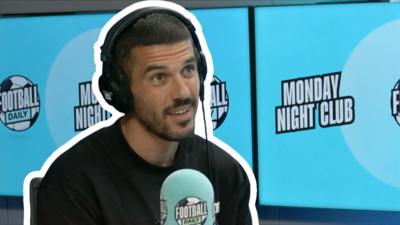 Conor Coady with Monday Night Club branded backdrop and microphone