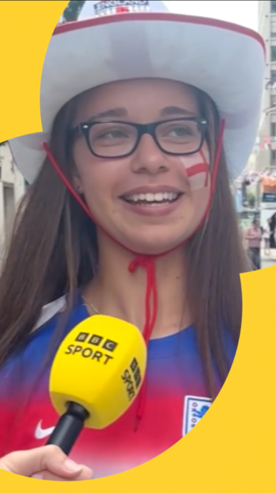 A woman wears an England cowboy hat and has the England flag painted on her left cheek