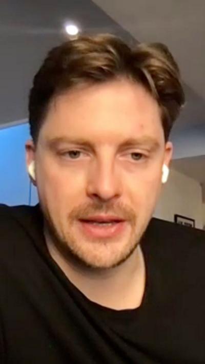 Dr Alex George who has short light brown hair and a short beard