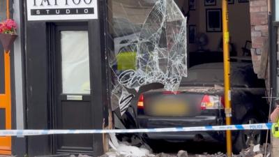 A car wedged in the shop window