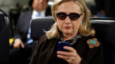 Hillary Clinton looking at her smart phone