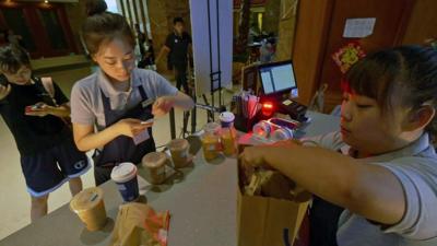 Women preparing coffee orders at Luckin Coffee