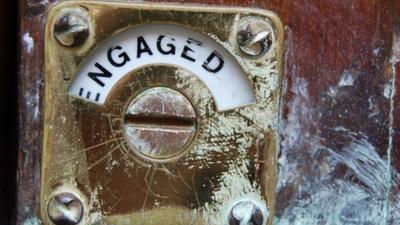 Engaged sign on public toilet door