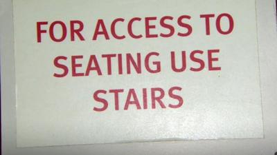 Sign reads 'For access to seating use stairs'