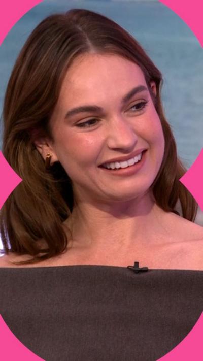 Lily James with her hair down, wearing a brown dress