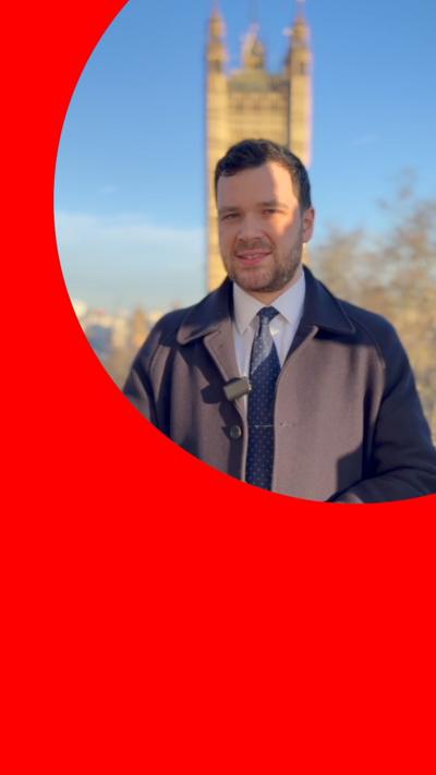 A man in a suit standing outside Westminster