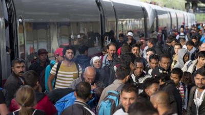 Refugees get out of a special train in Berlin that has arrived from Munich