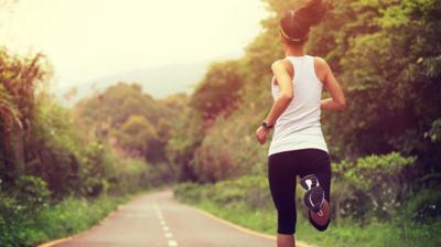 A woman running down a country road