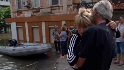 Woman is hugged in Kherson after evacuation from floods