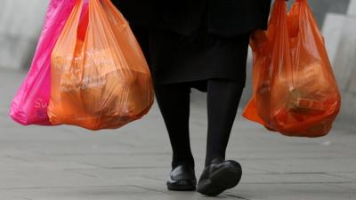 Woman holding plastic bags