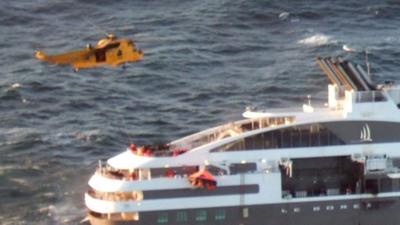 A RAF helicopter winching passengers from "Le Boreal"