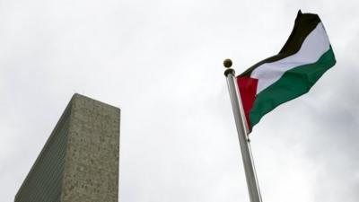 The Palestinian flag flies after being raised