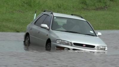 A stranded car in flood water in New Zealand