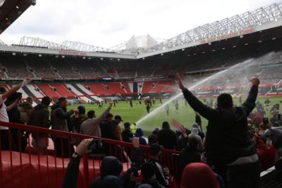 Manchester United fans protest on Old Trafford pitch