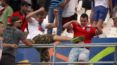 Russian fan kicking an England fan