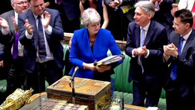 Theresa May looks back on her record at PMQs before she is cheered by colleagues as she leaves the chamber.