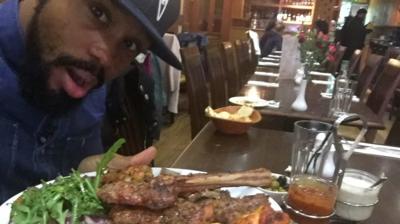 Newsbeat reporter Nesta McGregor poses with a plate of meat