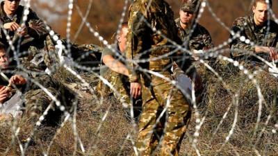 The Slovenian army build the barbed wire barrier on the border between Slovenia and Croatia