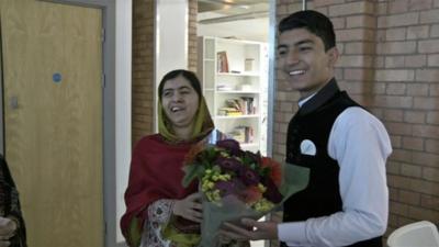 Malala Yousefzai receives flowers from Anwar Ullah