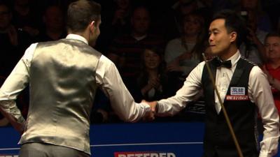 Mark Selby and Marco Fu shake hands after the longest-ever frame at the World Snooker Championship