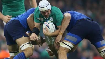 Two French players attempt to halt Rory Best's charge in Cardiff