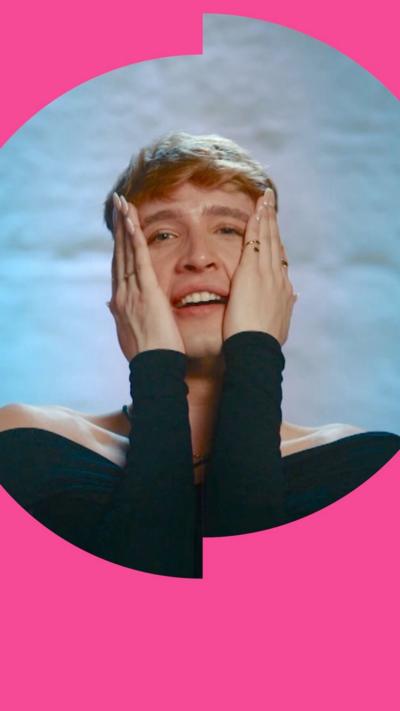 A man clutching his hands to his face