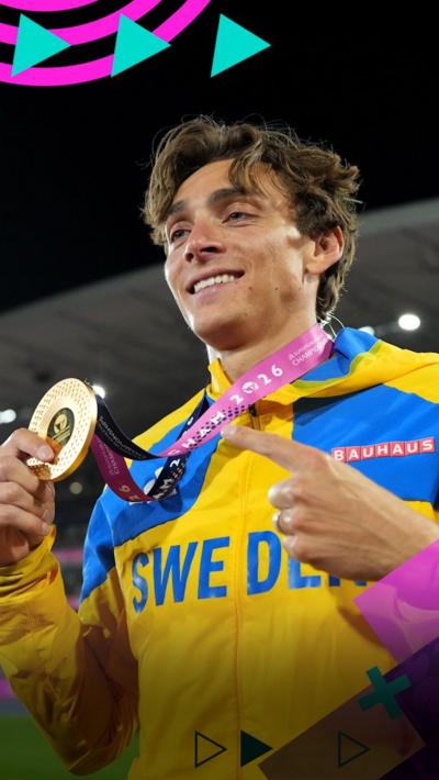Mondo Duplantis smiles while showing off his gold medal from the men's pole vault final.