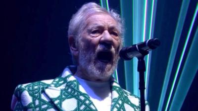 Sir Ian McKellen sings on stage at Glastonbury festival 