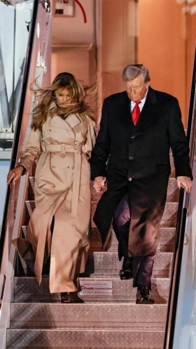 Donald Trump and First Lady Melania descend the steps from Air Force One in Stansted Airport