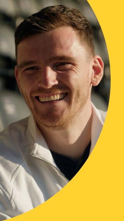 Andy Robertson smiling at the camera
