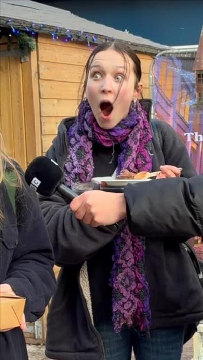 A woman visibly shocked, with her mouth wide open
