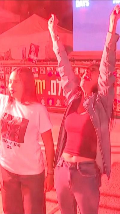 A woman raises her arms in celebration
