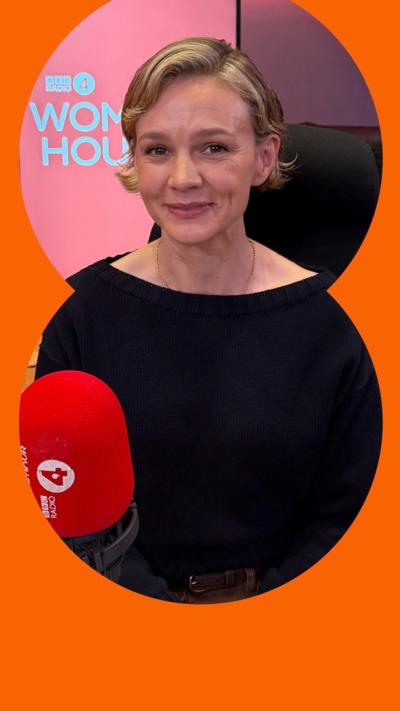 Carey Mulligan smiles in the Woman's Hour studio - she wears a black top and has short blonde hair