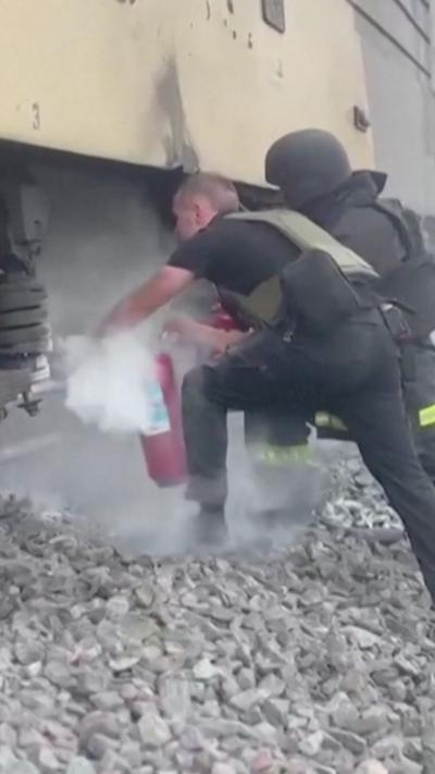 Emergency responders use fire extinguisher on train